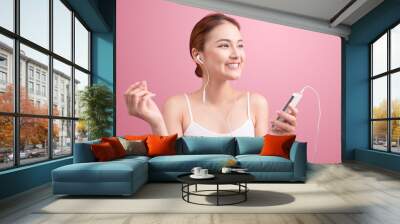 Happy asian girl dancing and listening to the music isolated on Wall mural