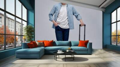 Happy young Asian tourist man holding baggage going to travel on holidays Wall mural