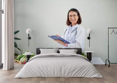 Portrait of female nutritionist in her office Wall mural