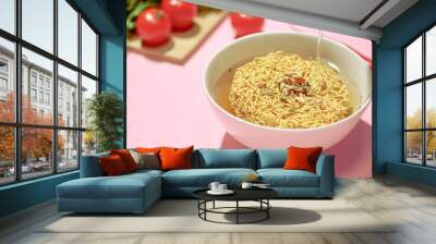 Pouring hot water into instant noodles in a bowl Wall mural