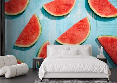 Slices of watermelon on blue wooden desk. Wall mural