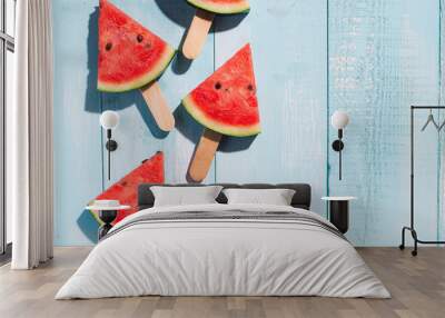 Slices of watermelon on blue wooden desk. Wall mural