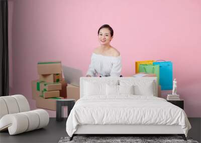 Woman packing item that she sells online. Wall mural