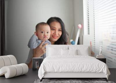 Woman with a baby doing a selfie Wall mural