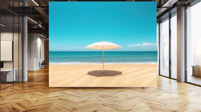 Beach umbrella casting soft shadows on golden sand, framed by the endless blue sky and ocean. Minimalist, tranquil summer vacation vibes in pastel colors Wall mural