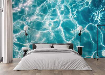 Crystal clear swimming pool surface with shimmering blue water reflecting sunlight and soft waves, perfect for a refreshing setting. Wall mural