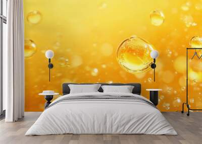 Golden yellow oil bubbles suspended in clear liquid creating an abstract composition of texture and color in fluid motion Wall mural