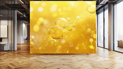 Golden yellow oil bubbles suspended in clear liquid creating an abstract composition of texture and color in fluid motion Wall mural