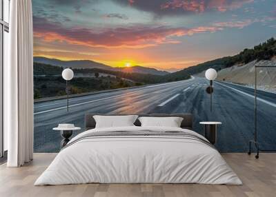 Panoramic sunrise view of an asphalt highway with natural mountain scenery, capturing the serene beauty of dawn. Wall mural