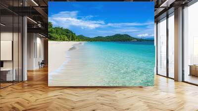 Serene beach with pristine white sand and clear turquoise waters under a bright sunny sky evoking tropical escape vibes Wall mural