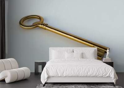 Shiny gold key lying on a smooth white surface, symbolizing success, unlocking potential, and achievement. Wall mural