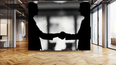 Silhouette of two individuals shaking hands, symbolizing a successful partnership or agreement. Wall mural