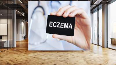 Doctor holding a paper card with text ECZEMA, medical concept Wall mural