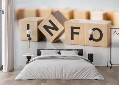 four wooden blocks with the letters info on the bright surface of a gray table, business concept Wall mural