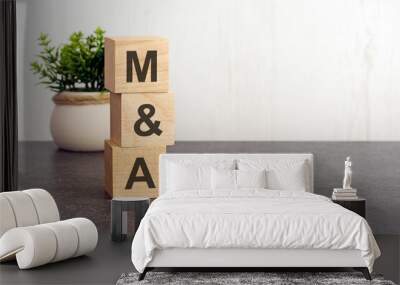 letters of the alphabet of MA on wooden cubes, green plant, white background Wall mural