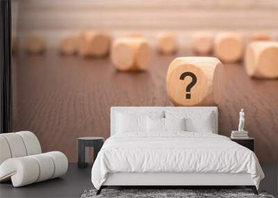 one wooden block with a question mark and a reflection from the table surface Wall mural