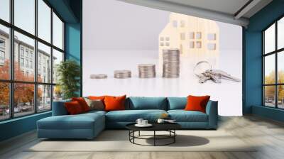 Stack of coins and a key on a gray background with model house with reflection Wall mural