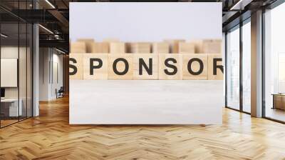 word sponsor inscribed on wooden cubes lying on a light table. economy and investments concept. Wall mural