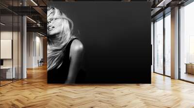 Beautiful young woman with curly blond hair. Fashion studio shot. Black and white image Wall mural