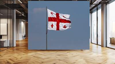 Georgia flag on blue sky background Wall mural