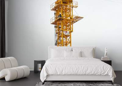 two modern yellow construction cranes above sky Wall mural