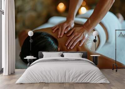 Masseur doing massage on body in spa salon with candles. Wellness therapy, treatment woman back Wall mural