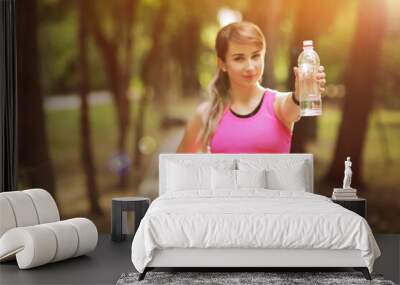 Beautiful fitness athlete runner woman drinking water in the park. Water bottle Wall mural