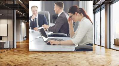 Young attractive business woman working in the office, developing her strategy Wall mural