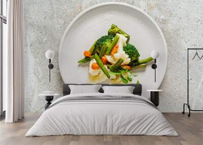 boiled vegetables on the white plate Wall mural