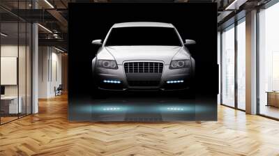 Front view of a luxury sport sedan isolated on black Wall mural