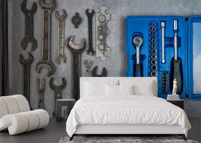 Old rusty wrenches vs new instruments in blue case on grey background Wall mural