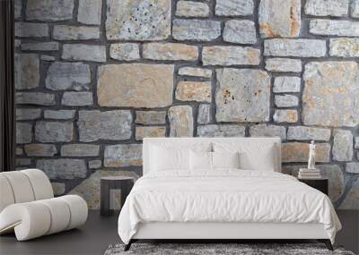 Grey stone wall with interesting texture of stones. Vintage background of grey wall. Wall mural