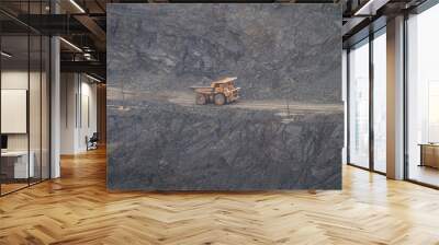 Large dump truck for removal of rock mass from the quarry for open-pit mining of minerals. Initial stage of melalurgy, machinery for the extraction of raw ore. Wall mural