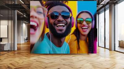 A group of friends from different cultural backgrounds, all wearing headphones and smiling brightly, with a vibrant, color-filled background that symbolizes the joy of music and un Wall mural