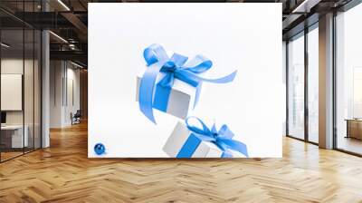 Christmas gift. White gift box with blue ribbon, New Year balls in xmas composition on white background for greeting card. Winter festive composition with copy space. Wall mural