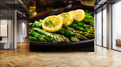 Deliciously prepared asparagus with lemon slices on a dark plate for a vibrant dinner presentation Wall mural