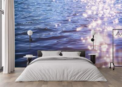 Sunlight twinkling off river water with small waves. Calm summer evening. Colorful background Wall mural