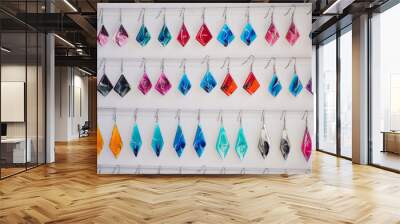 Many colored earrings on a white background. Concept of sales Wall mural