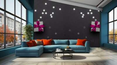 New years background. Christmas gifts with red ribbon on black b Wall mural