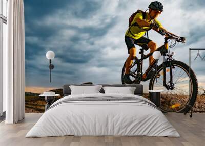 Cyclist Riding the Mountain Bike on Rocky Trail at Sunset. Extreme Sport and Enduro Biking Concept. Wall mural