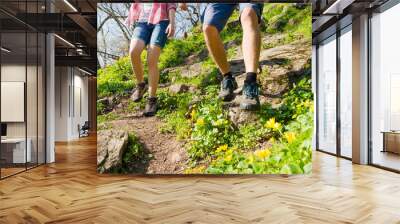 Young Couple Hiking with Backpacks on the Beautiful Rocky Trail at Sunny Evening. Family Travel and Adventure. Wall mural