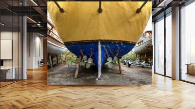 Rear side, stern  of the wooden old ship with two propellers and rudder, dry dock. Wall mural