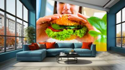 Veggie sandwich healthy vegan burger. Cute cheerful girl eating vegetarian hamburger with salad, avocado, vegetable. Hamburger vegan healthy diet food. Wall mural