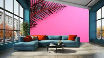 Vibrant pink backdrop featuring a lush tropical leaf creating a bold visual contrast Wall mural