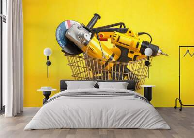 Shopping basket with elecric tools and construction equipment angle grinder, electric drill and jigsaw on yellow. Selling and buying online. Wall mural