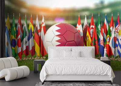 Soccer football ball with flags of world countries on the grass of football arena. Cup of world in Qatar. Wall mural