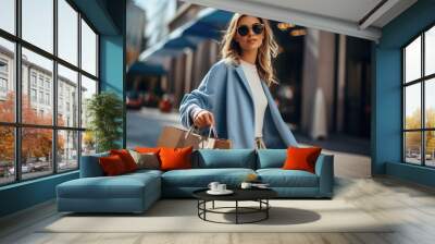 A woman walks down the street with shopping bags, past shop windows Wall mural