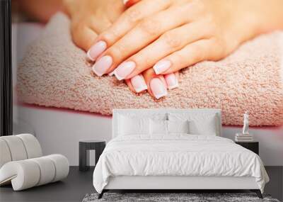 Beautiful woman hands with fresh french manicure Wall mural