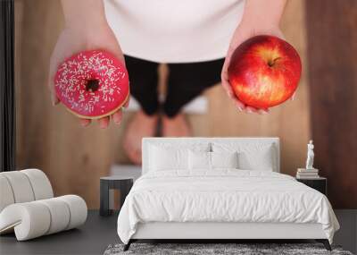 Diet. Woman Measuring Body Weight On Weighing Scale Holding Donut and apple. Sweets Are Unhealthy Junk Food. Dieting, Healthy Eating, Lifestyle. Weight Loss. Obesity. Top View Wall mural