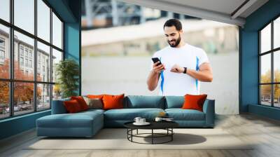 Fitness. Young man running in urban environment Wall mural